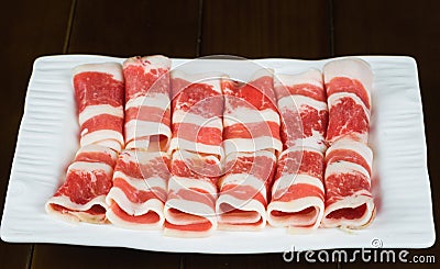 Fresh beef slides on white dish with dark background Stock Photo