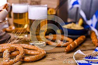 Fresh beer with foam on a wooden background. Oktoberfest German Pretzels Stock Photo