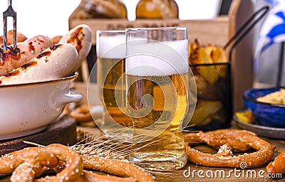 Fresh beer with foam on a wooden background. Oktoberfest German Pretzels Stock Photo