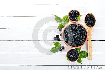 Fresh berries blackberries. On a black wooden background. Top view. Stock Photo