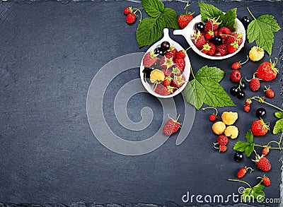 Fresh Berries on Slate Background (Strawberries, Raspberries and Stock Photo