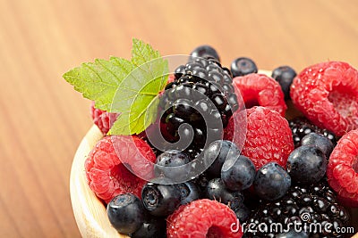 Fresh berries in wood bowl Stock Photo