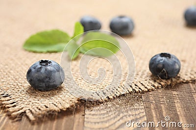 Fresh blueberries on a background of burlap and wooden Stock Photo