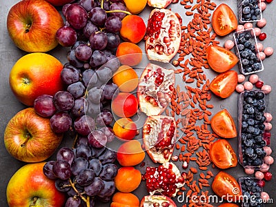 Fresh blueberries, cranberrys, apricots, apples, tomatoes, pomegranate, grape mix of fruit, flat lay, rich in resveratrol, Stock Photo