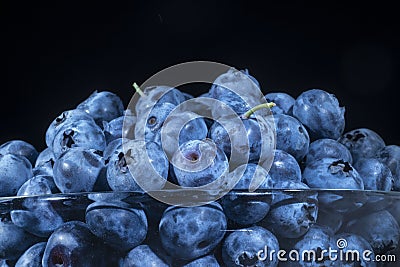 Fresh blueberries in in glassware on black background. Close-up of Bog bilberry, bog blueberry, northern bilberry or western Stock Photo