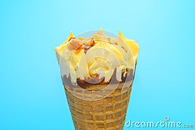 A fresh blueberry and cheese flavor ice cream cone on blue background Stock Photo