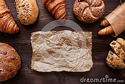 Fresh bread on the dark wooden background top view Stock Photo