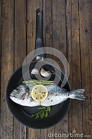 Fresh bream fish with herbs and spices on a pan Stock Photo