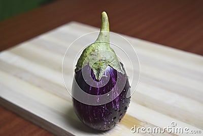 Fresh brinjal vegetable on chopping board Stock Photo