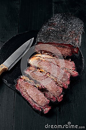 Fresh Brisket BBQ beef sliced for serving against a dark background Stock Photo