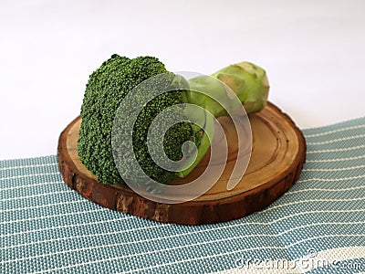 Raw fresh broccoli on old wooden table. Stock Photo