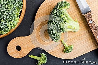 Fresh broccoli with knife on bleck table Stock Photo