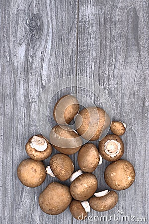 Fresh brown mushrooms on a wooden background. Stock Photo