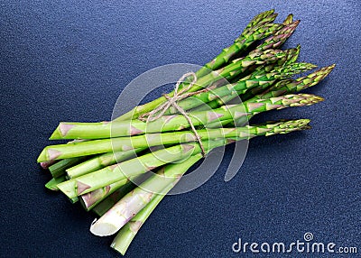 Fresh bunch asparagus on blue table background Stock Photo