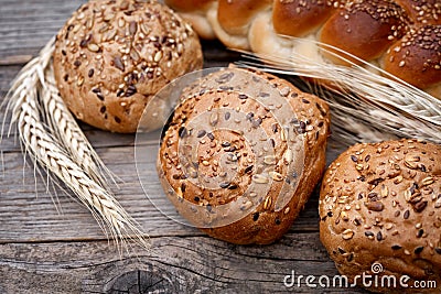 Fresh buns with whole grains on a wooden table Stock Photo