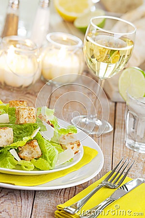 Fresh Caesar salad on a rustic table in bright light Stock Photo