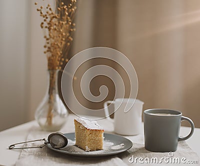 Fresh cake, pitcher and cup of coffee. Piece of fresh homemade cake with cup of cappuccino on a table. Morning breakfast Stock Photo
