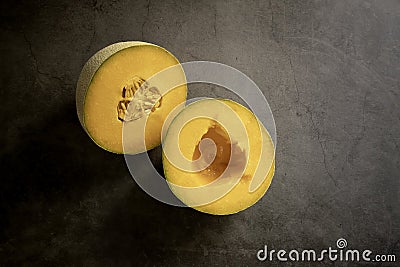 Fresh Cantaloupe on a Brown Cement Textured Background Stock Photo