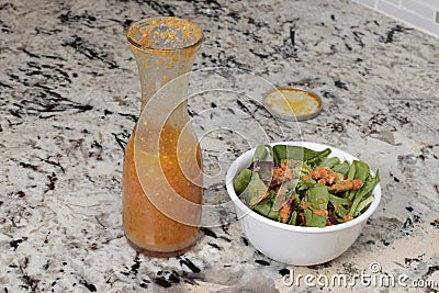 Fresh Carrot Ginger Salad Dressing with Spring Mix Greens Stock Photo