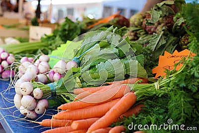 Fresh Carrots and beads at a farmer market in France, Europe. Italian carrots. Street French market at Nice. Stock Photo