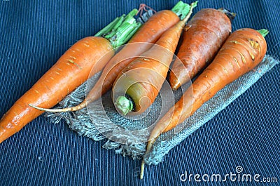 Fresh carrots closeup on a dark tablecloth Stock Photo