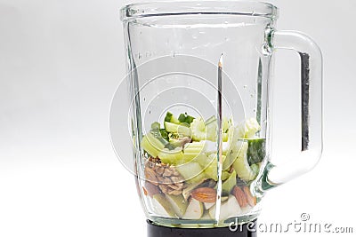 Fresh Celery, avocado, almonds, pears in a glass blender for cooking a green smoothie Stock Photo