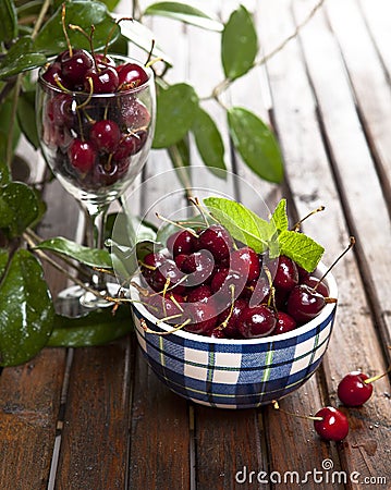 Cherries fruit in a plate on a wooden table Stock Photo