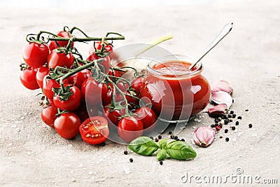 Fresh cherry tomato sauce on rustic background with cherry tomatoes. Stock Photo