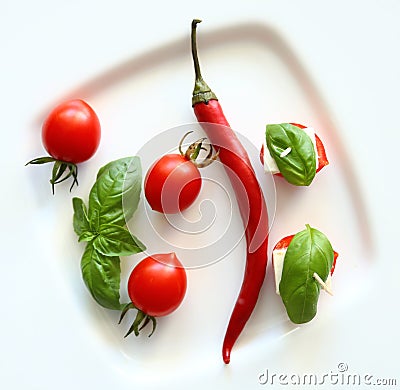 Fresh cherry tomatoes, chees and chili on white Stock Photo
