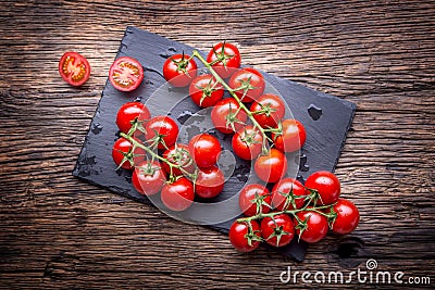 Fresh cherry tomatoes. Ripe tomatoes on oak wooden background Stock Photo