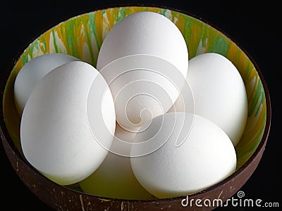 Fresh chicken eggs in a vietnamese coconut bowl Stock Photo
