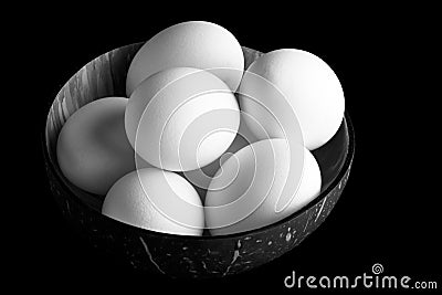 Fresh chicken eggs in a vietnamese coconut bowl Stock Photo