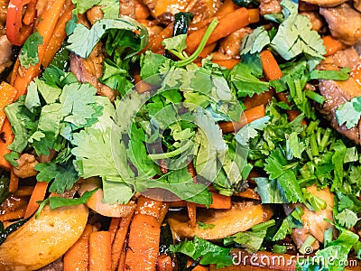 Fresh chopped cilantro on fried vegetables Stock Photo