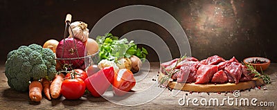 Fresh chopped meat with rosemary and fresh vegetables for cooking Stock Photo