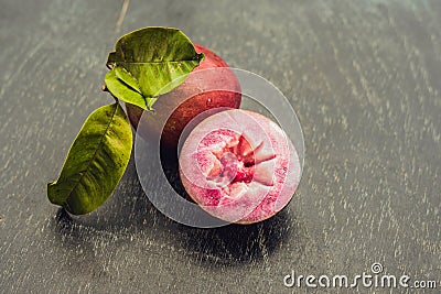 Fresh Chrysophyllum cainito fruits on wood background Stock Photo