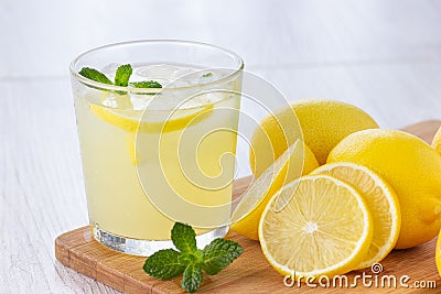 Fresh citrus lemonade water with lemon, mint and ice. Stock Photo