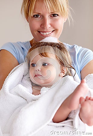 Fresh, clean and precious. a mother carrying her newly washed baby in a towel. Stock Photo