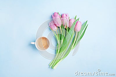 Fresh coffee and pink tulip flowers on pastel background top view. Beautiful spring breakfast on Mothers or Womans day. Flat lay. Stock Photo