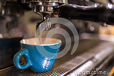 Fresh coffee prepared in the a coffee machine. Espresso in small white cups Stock Photo