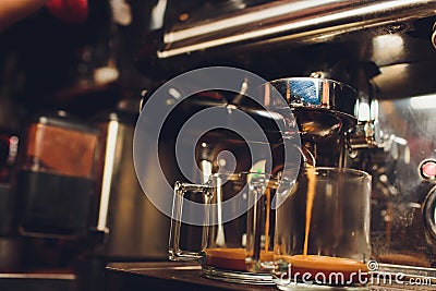 Fresh coffee prepared in the coffee machine. Espresso in small white cups. Stock Photo