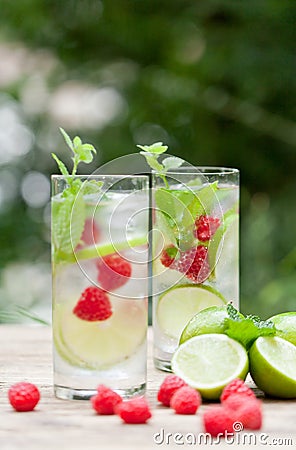 Fresh cold drink water ice cubes peppermint lime raspberry Stock Photo