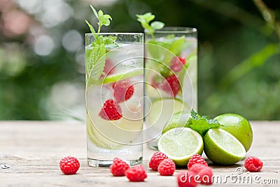 Fresh cold drink water ice cubes peppermint lime raspberry Stock Photo