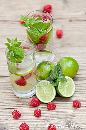 Fresh cold drink water ice cubes peppermint lime raspberry Stock Photo