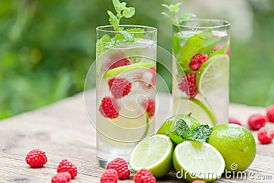 Fresh cold drink water ice cubes peppermint lime raspberry Stock Photo