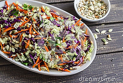 Fresh Cole slaw with pumpkin, flax, sesame seeds and pine nuts - delicious healthy vegetarian food. Stock Photo