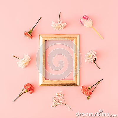 Fresh colorful flowers and gloden frame on pastel pink background. Minimal spring or summer concept. Romantic flowers layout. Copy Stock Photo