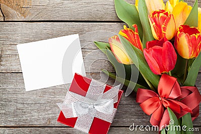 Fresh colorful tulips with gift box and greeting card Stock Photo