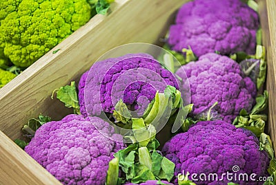 Fresh colorful vegetables on the counter of the store: purple cauliflower, Brussels sprouts Stock Photo