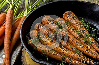 Fresh cooked carrots in a cast iron skillet Stock Photo