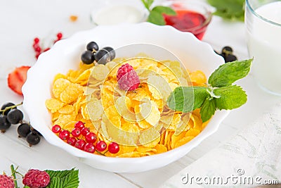 Fresh corn flakes with strawberries and milk close up Healthy tasty breakfast cornflakes with strawberries, raspberries Stock Photo